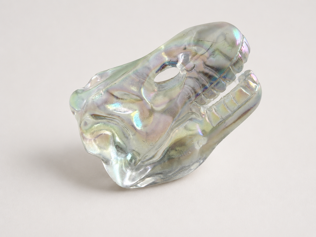 Aura coated clear quartz dinosaur skull carving