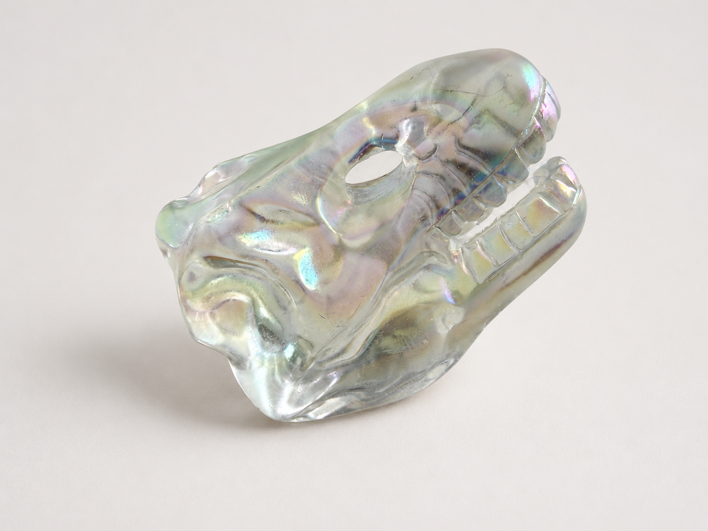 Aura coated clear quartz dinosaur skull carving